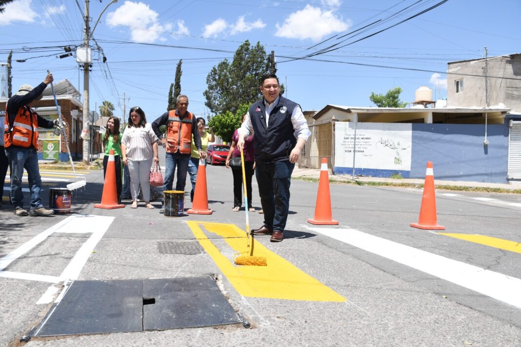 Alfredo Chávez participa en la pintura de pasos peatonales en escuelas de la colonia Panorámico para fortalecer la seguridad vial de estudiantes y familias.